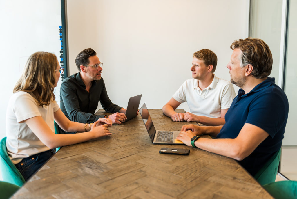 Employees discussing and holding a business meeting
